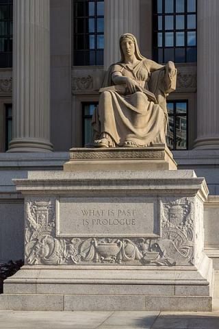 Marble statue with the inscription, "What is Past is Prologue."