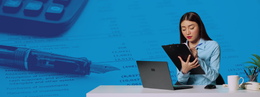 Woman with a clipboard at a desk. In the background is a pen, calculator, and a spreadsheet.